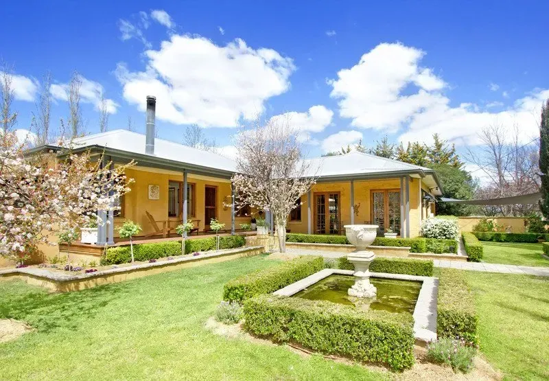 A large house with a fountain in front of it