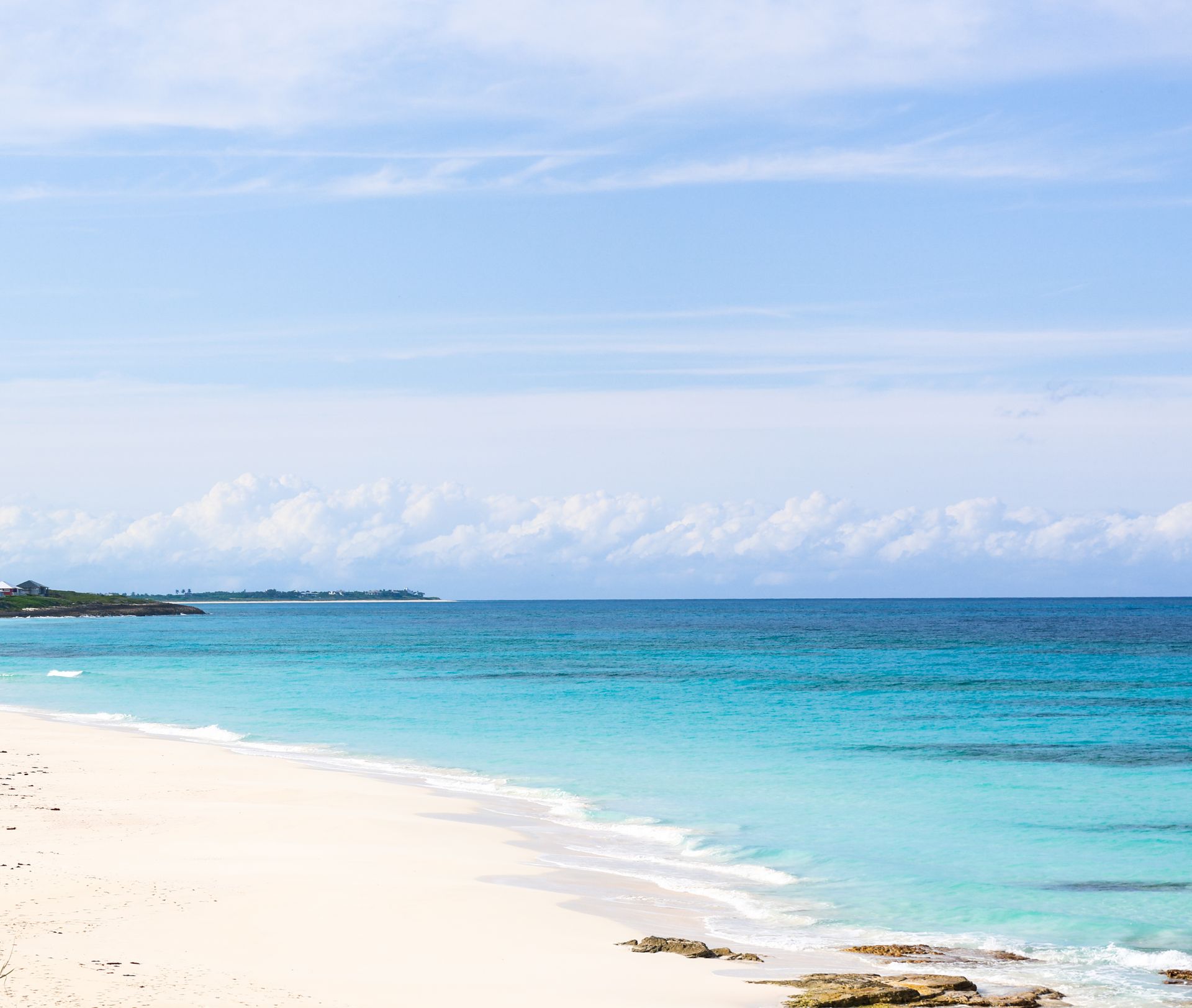 White sandy beach with turquoise water and a clear blue sky