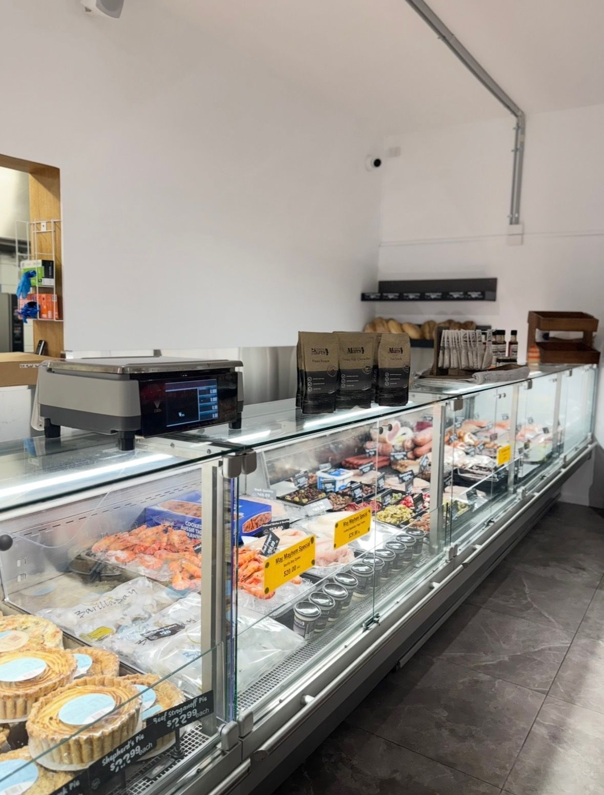 Glass bakery display case with assorted pastries and cakes in a bright café interior