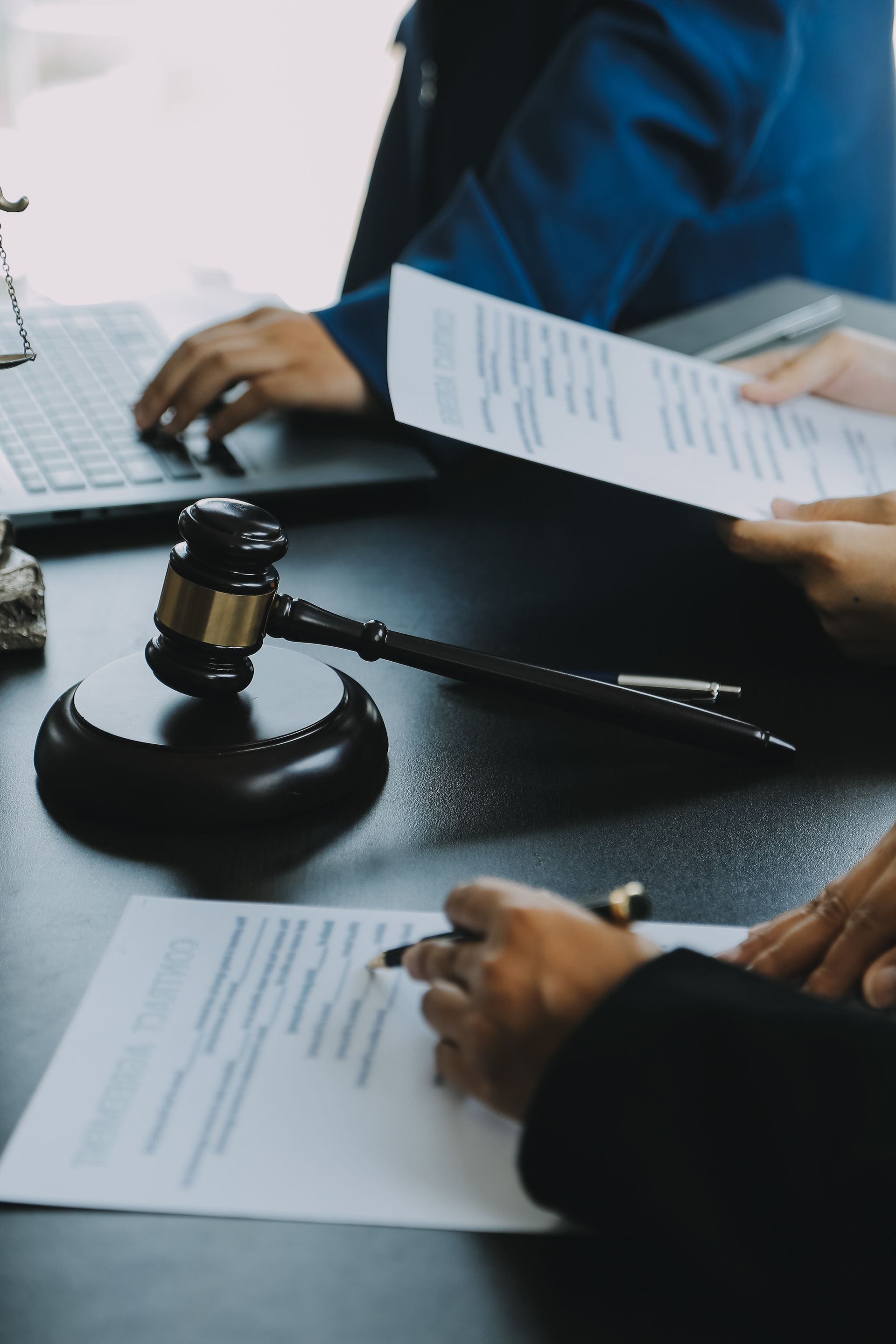 Judge gavel with Justice lawyers having team meeting at law firm in background. Concepts of law. Judge gavel with Justice lawyers having team meeting at law firm in background. Concepts of law.