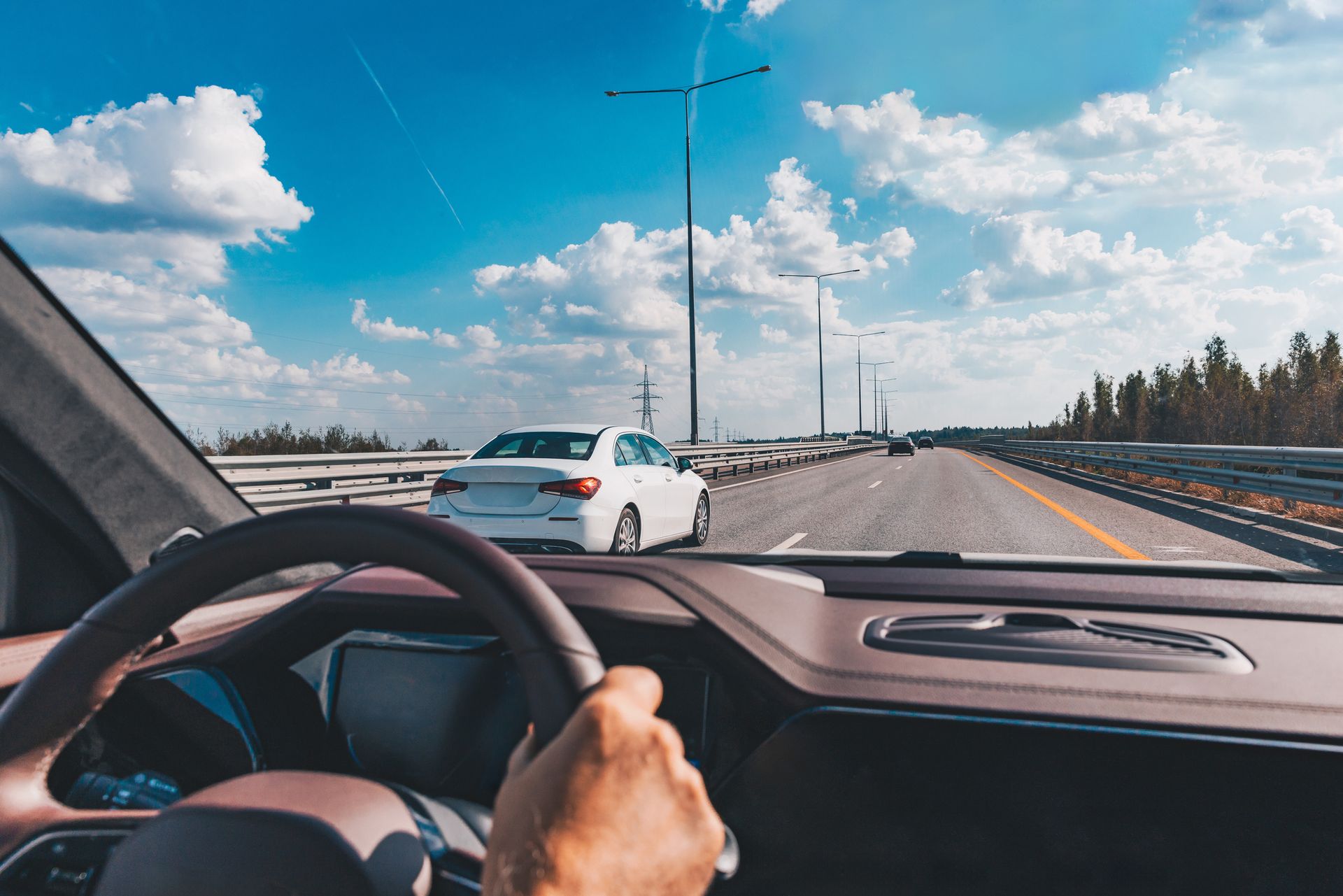 Man driving modern car from rear view on the highway. Man driving modern car from rear view on the highway.