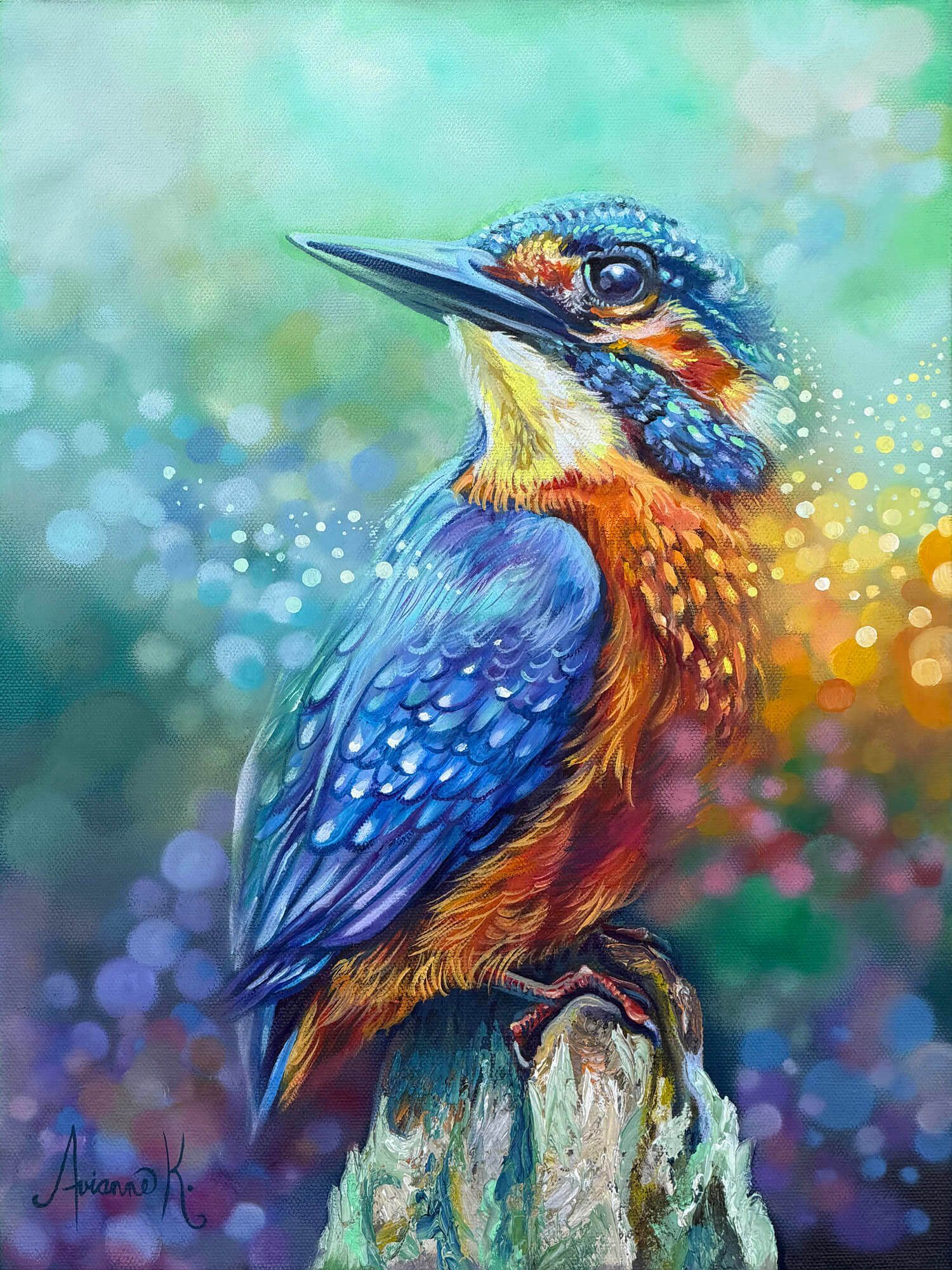 Colorful kingfisher perched on a branch, with blue and orange feathers against a soft bokeh background.
