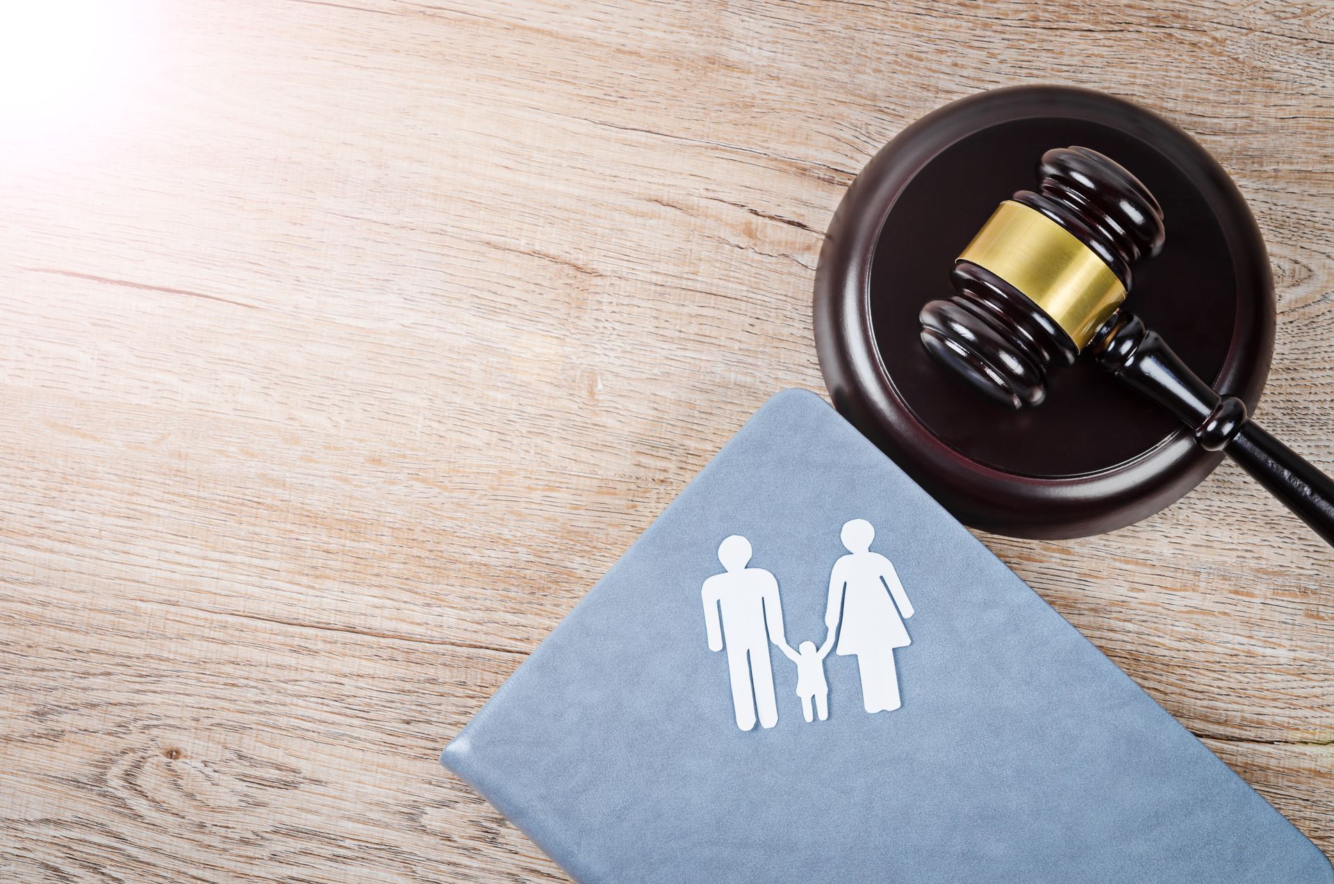 Gavel and family law book with custody icon, representing child custody law and legal decisions.