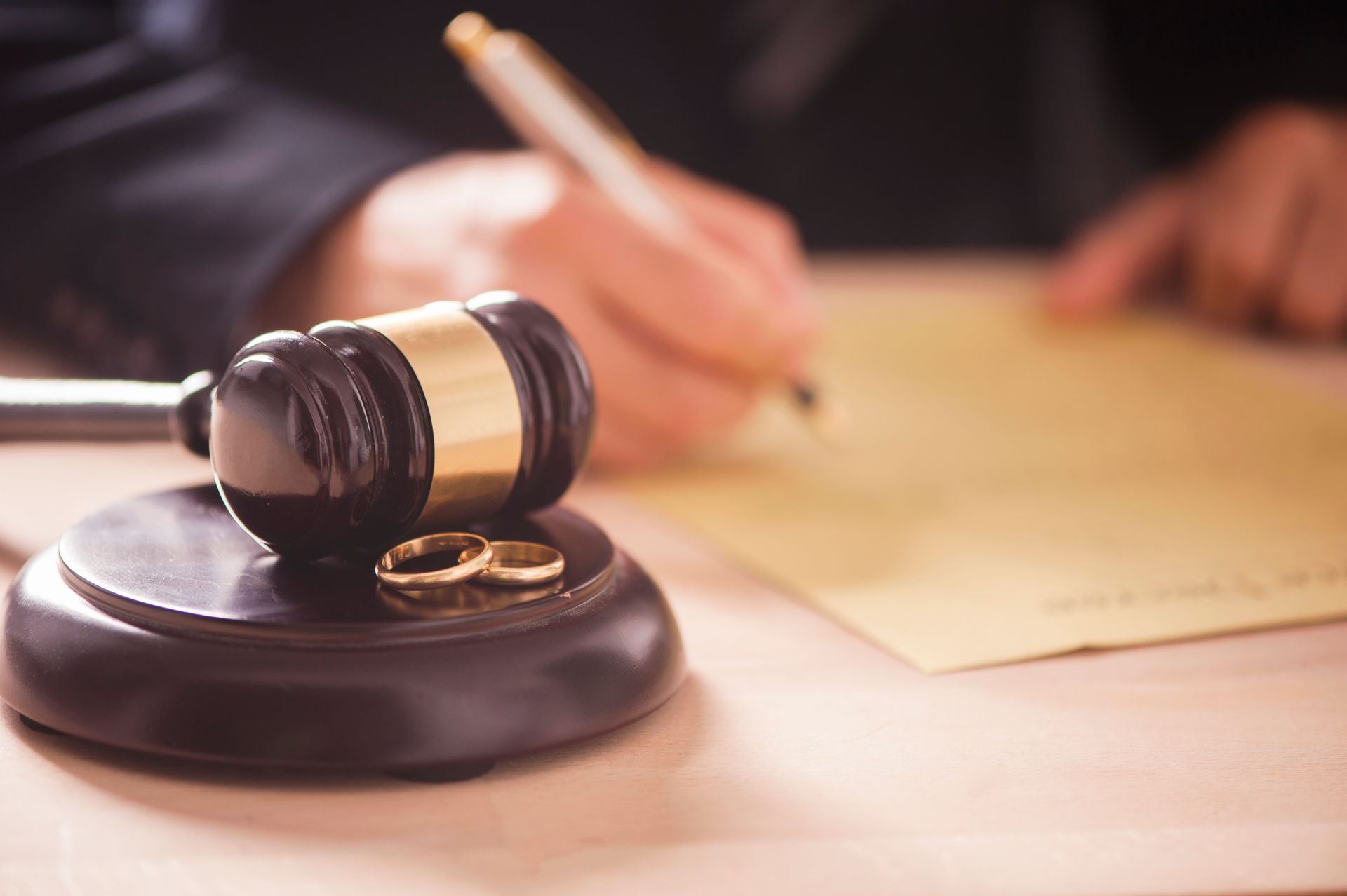 Gavel, wedding rings, and legal document symbolizing divorce attorney services in Pinellas Park, FL