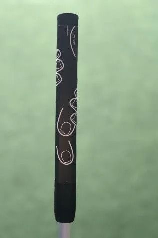 Black pen with white doodle patterns on a light green background