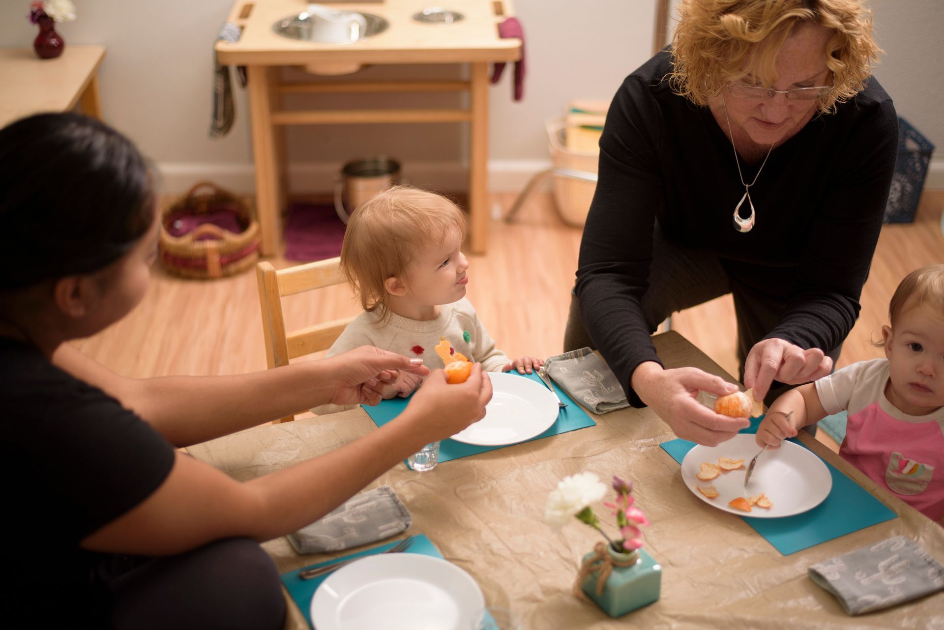 Montessori toddlers and guides during snack time