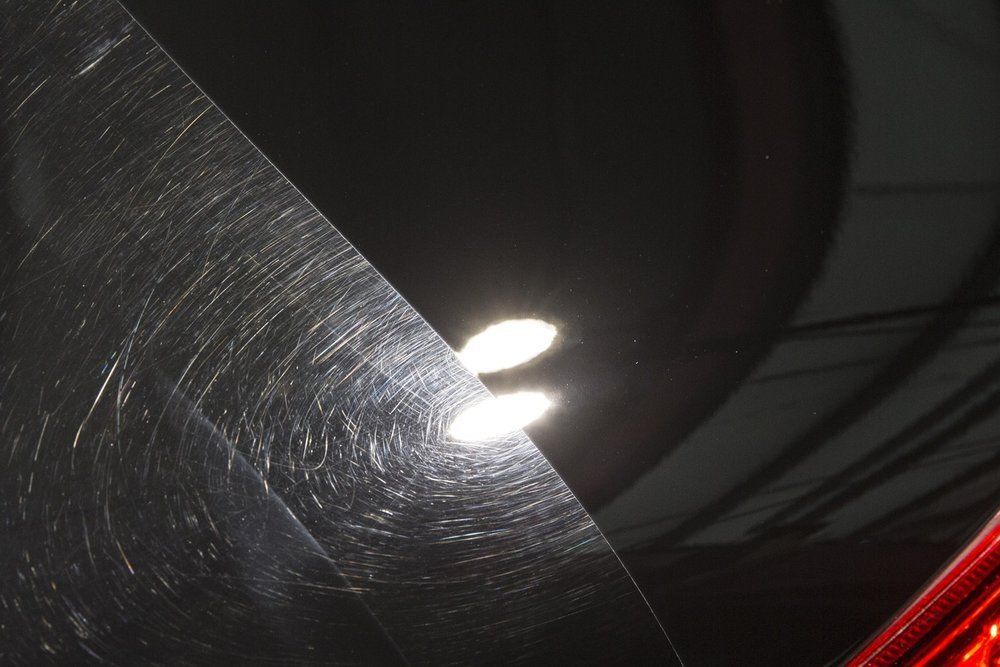 A close up of a black car with a light shining on it
