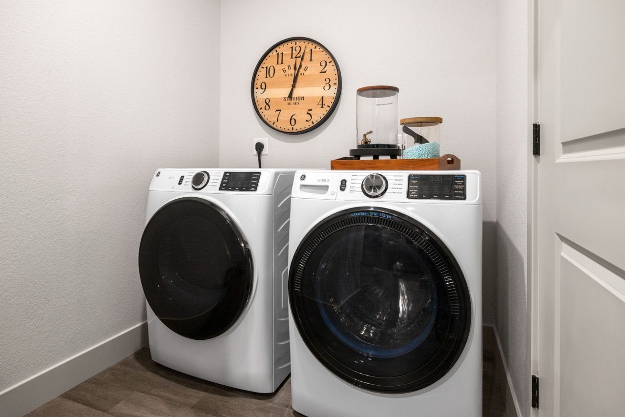 Front view of a white washer and dryer in a laundry closet.