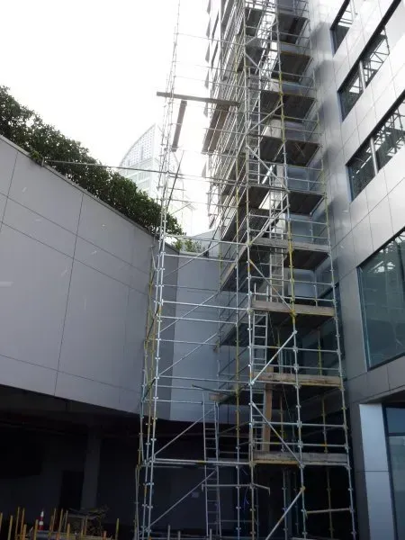 A modern building with scaffold giving access to make repairs on a tall building