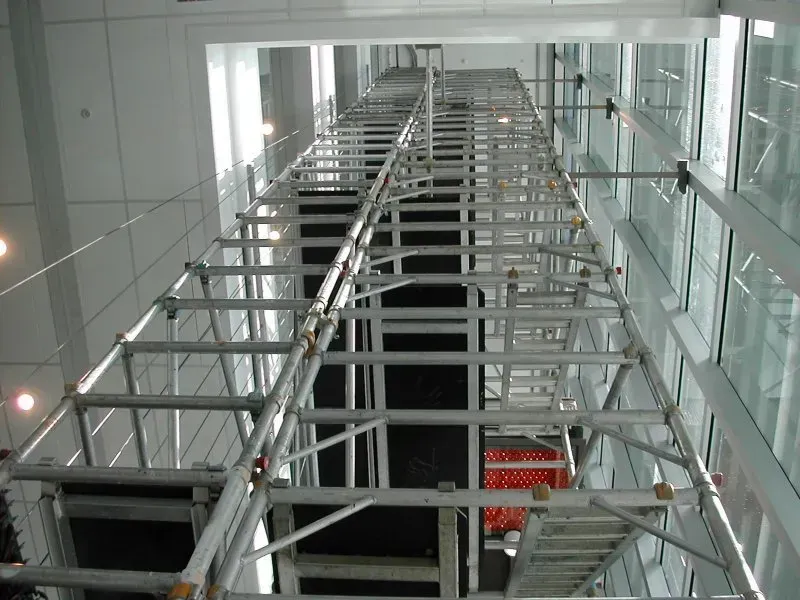 A large mobile  scaffold structure in a building in a tight space
