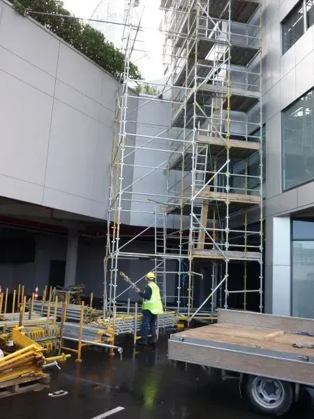 A modern building with scaffold giving access to make repairs on a tall building