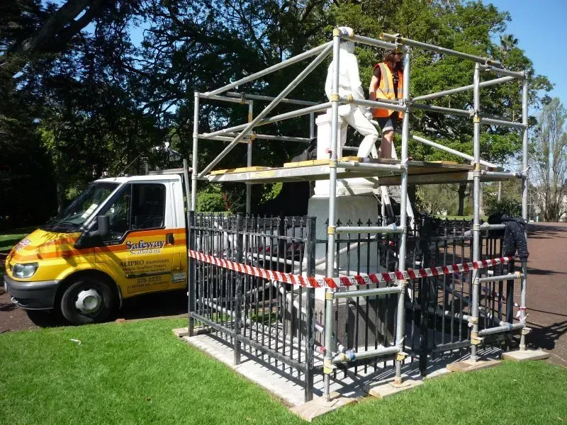 A small scaffold around a sculpture