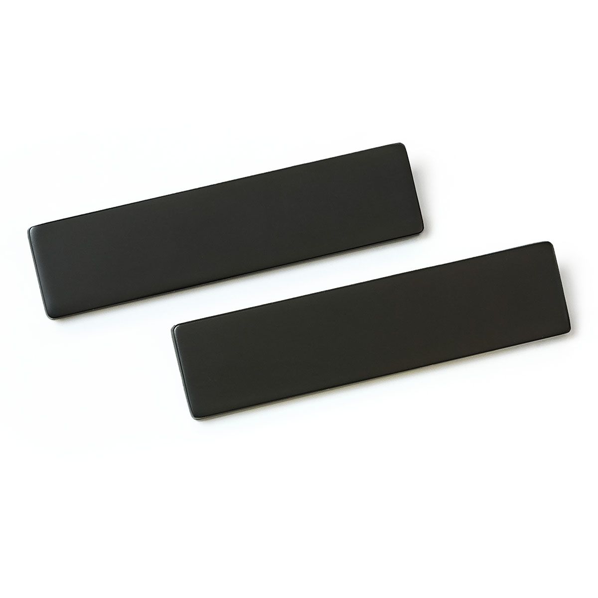 Two black rectangles are sitting on top of each other on a white surface.