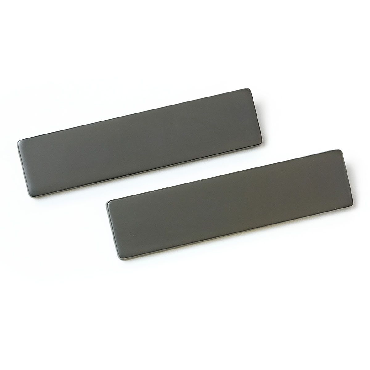 Two gray rectangles are sitting on top of each other on a white surface.
