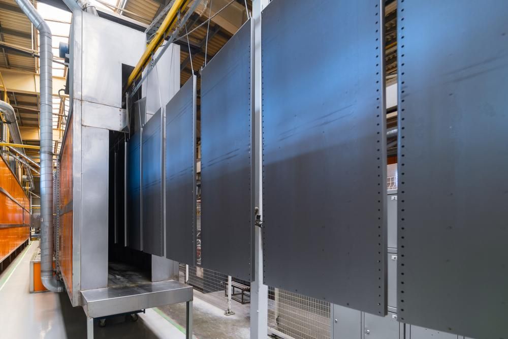 A Factory With a Lot of Boxes Hanging From the Ceiling — Alamo Powder Coaters in Heathcote, NSW