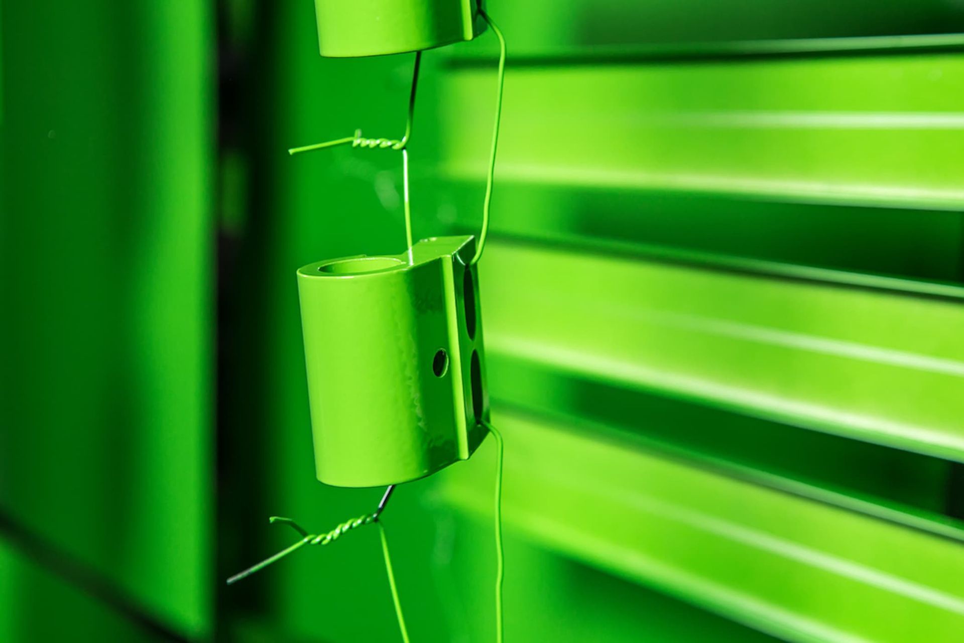 A Close-up Of a Green Blind on A Window — Alamo Powder Coaters in Unanderra, NSW