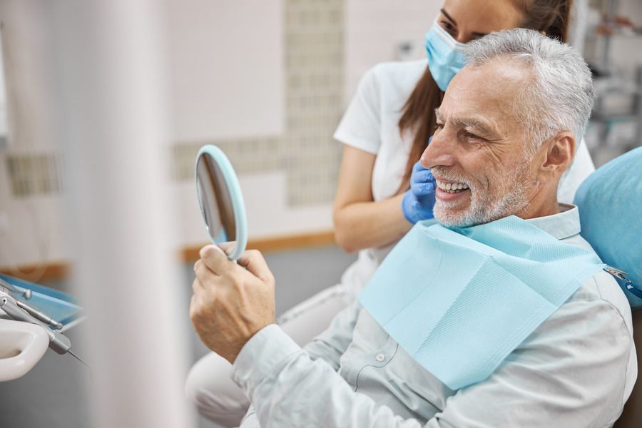Older man smiling in front of mirror | Highland Park NJ and Monroe Township