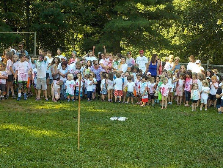 A large group of people standing in a grassy field