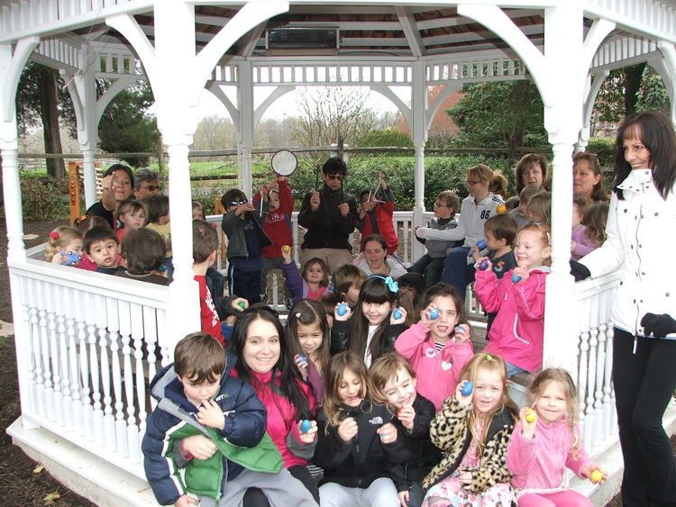 A group of children are posing for a picture in a gazebo