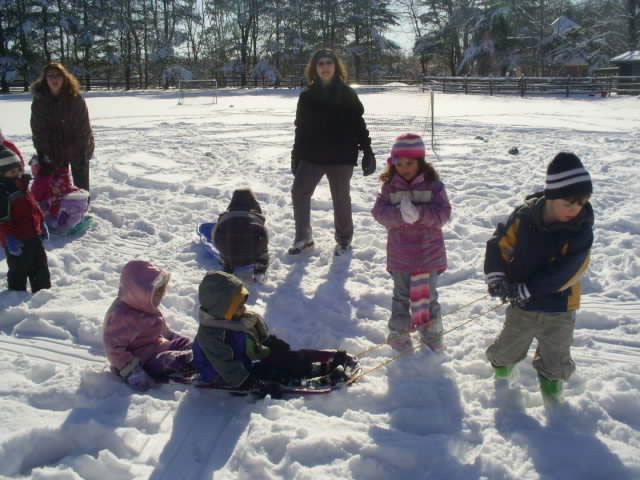 A group of children are playing in the snow