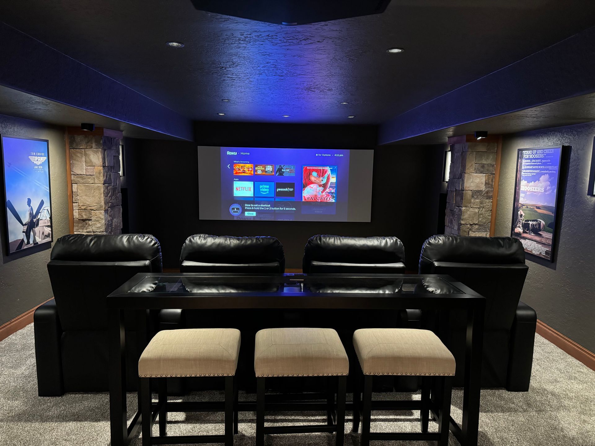 There is a projector screen in the middle of the room.