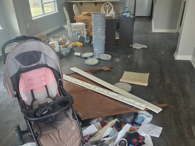 Discarded stroller, broken furniture, and left-behind household trash from an apartment eviction cleanout in Las Vegas by Hot Mess Cleanup & Junk Removal.