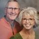 A man and a woman wearing glasses are posing for a picture.