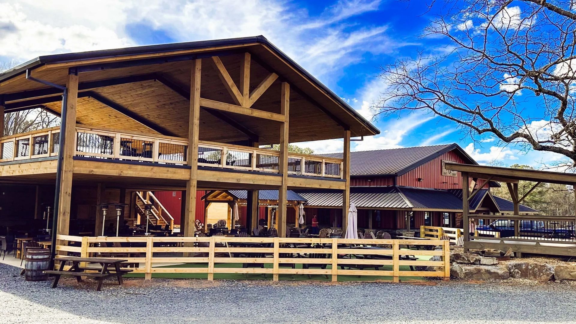 A large wooden building with a fence in front of it