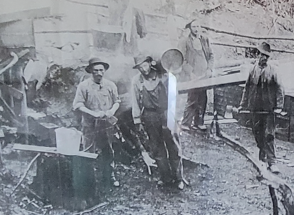 A group of men are standing next to each other in a black and white photo.
