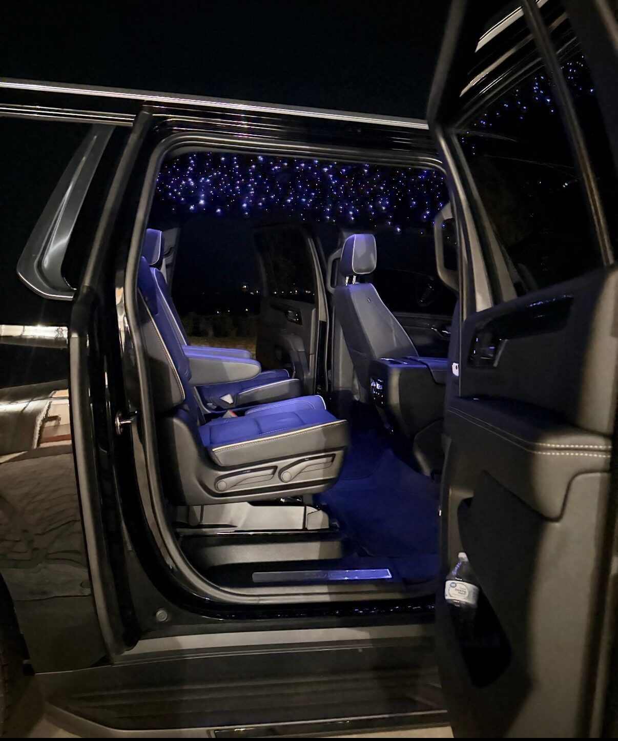 Rear captain's chairs under the starlight roof of a 2026 GMC Yukon XL used for prom night limo service in Portland