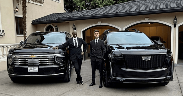Two chauffeurs beside two black Cadillac Escalades at a stucco house, booked through our executive car service in Portland, Oregon