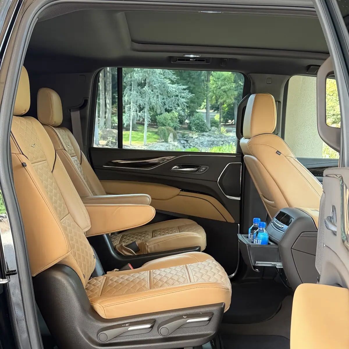 Driver in a Black Cadillac Escalade picking up client in Westland, Oregon, for an hourly car long distance car service 