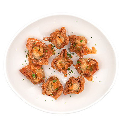 White plate with fried dumplings topped with herbs, arranged in a circle