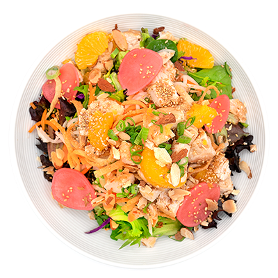 Colorful salad with orange slices, greens, pink tomatoes, shredded vegetables, and sesame seeds on a white plate