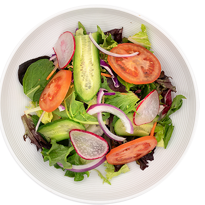 Mixed green salad with tomato, cucumber, radish, and red onion in a white bowl