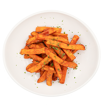 White bowl of seasoned sweet potato fries with herbs, viewed from above
