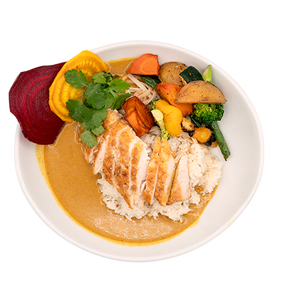 Grilled chicken over rice with orange sauce, roasted vegetables, beet slices, and cilantro in a white bowl