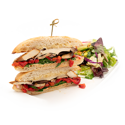 Club sandwich with lettuce, tomato, and fries on a white plate with a side salad.