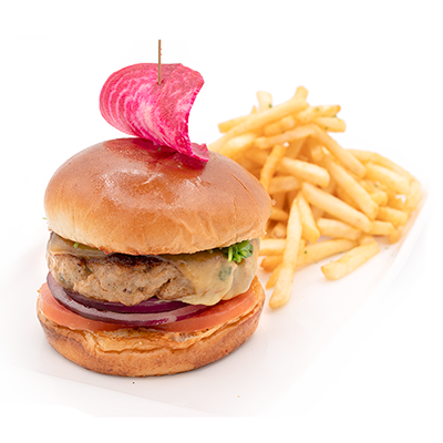 Burger with fries on a white plate, topped with a pink garnish