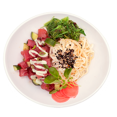 Assorted colorful noodle and vegetable salad in a white bowl with herbs and sesame seeds