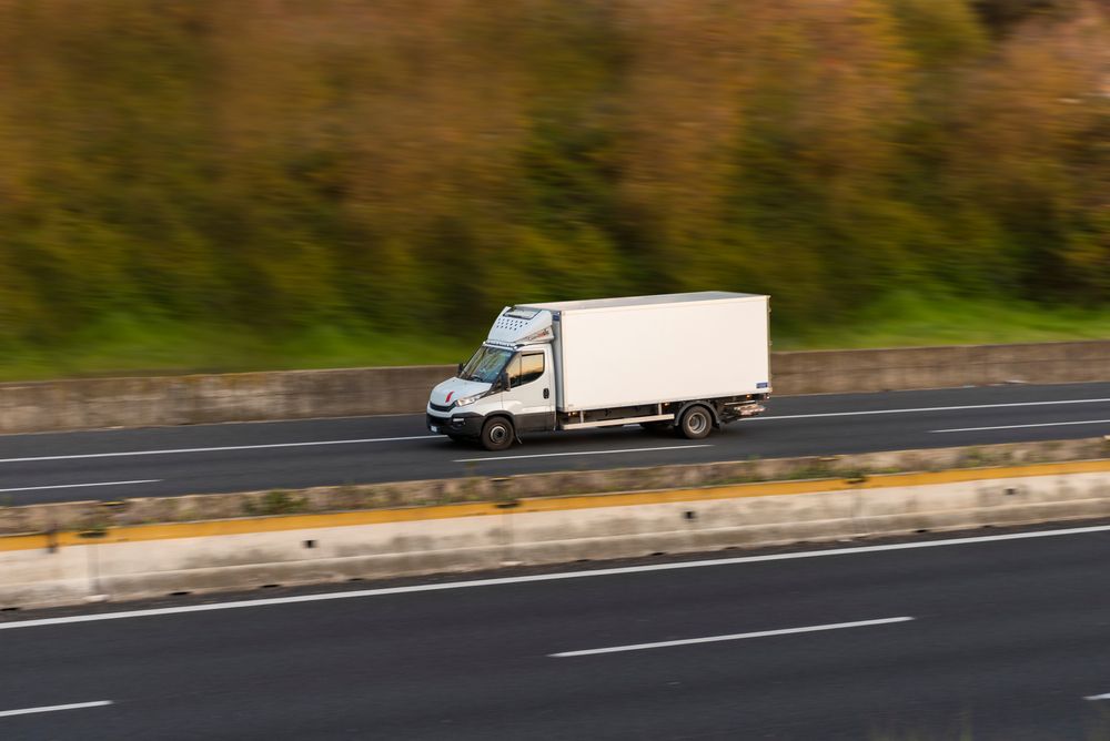 A White Truck is Driving on a Flat Road — Ready To Move in Brunswick Heads, NSW