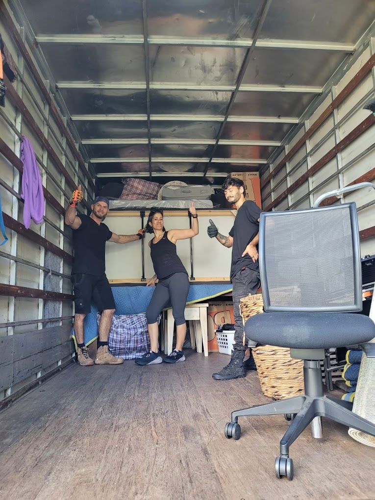 A Team of Removalists Are Standing in the Back of a Truck — Ready To Move in Ocean Shores, NSW