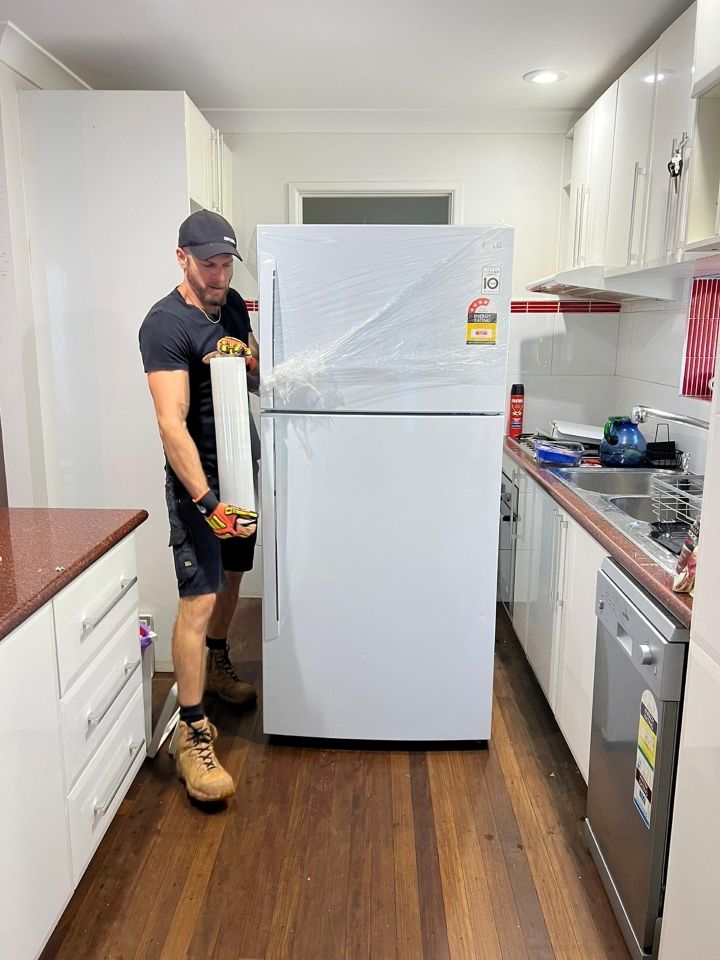 A Man is Preparing a Refrigerator for Removal — Ready To Move in Pottsville, NSW