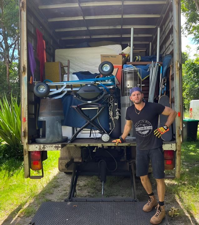 A Man is Standing Behind a Truck — Ready To Move in Murwillumbah, NSW