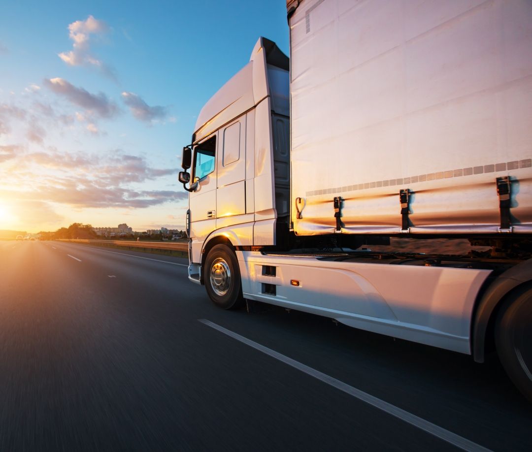 A White Truck is Driving Down a Highway at Sunset — Ready To Move in Ocean Shores, NSW