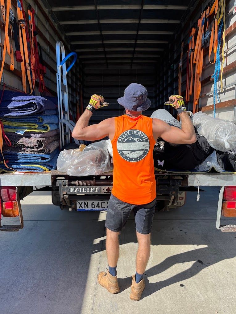 A Man in a Branded Shirt is Standing Next to a Truck — Ready To Move in Mullumbimby, NSW