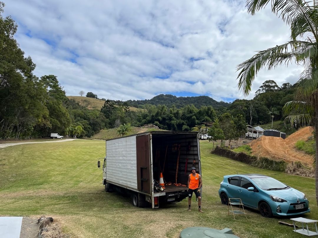 A Man is Standing Next to a Truck in a Field — Ready To Move in Tweed Heads, NSW