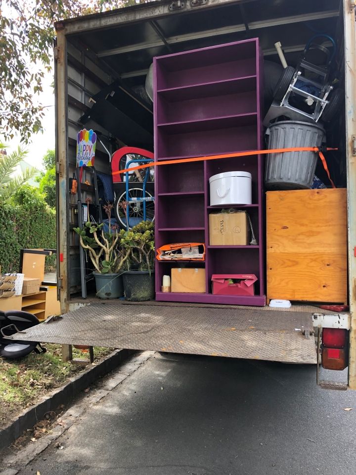 A Moving Truck Filled With Purple Shelves and Other Items — Ready To Move in Bangalow, NSW