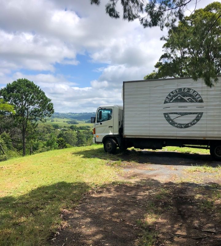 A White Truck is Parked on Top of a Grassy Hill — Ready To Move in Pottsville, NSW