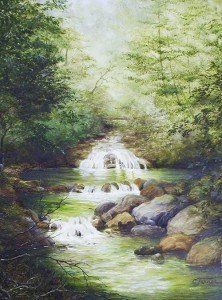 A serene stream cascades over rocks, surrounded by lush green foliage and trees.